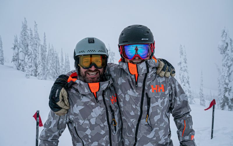 off-piste-skiing-skiers-pose-for-a-photo-min
