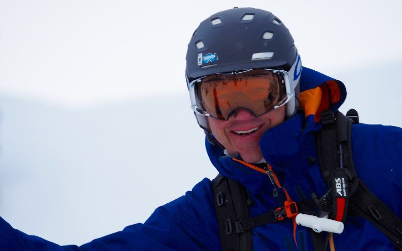 heli-skiing-bc-prices-smiling-man-min