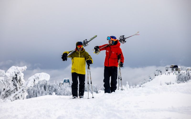 heli-skiing-bc-prices-two-skiers-min
