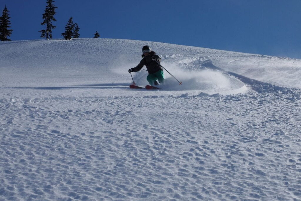 helicopter-skiing-canada-skier-going-down-mountain